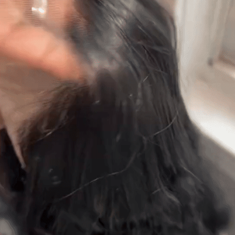 Long wavy black synthetic lace front wig shown on a mannequin