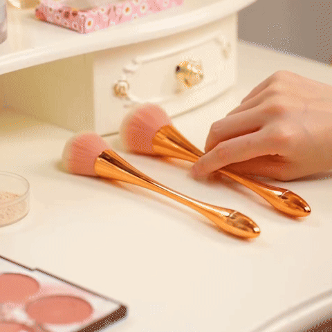Cosmetic brush with rose gold fan design on white background