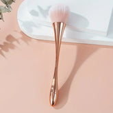 Soft-bristle cosmetic brush beside compact powder